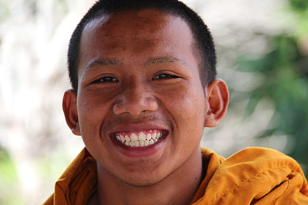 man wearing yellow jacket smiling on camera thumbnail