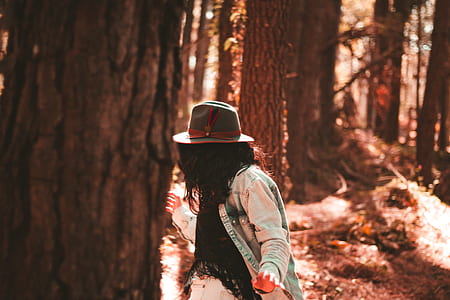 person standing beside tree thumbnail