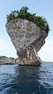 gray rock formation in middle of body of water thumbnail