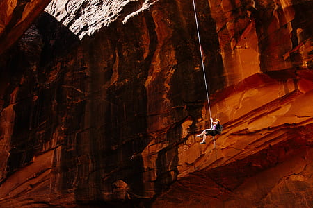 person hanging on rock mountain thumbnail
