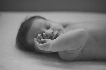selective photo of topless baby wiping eye thumbnail