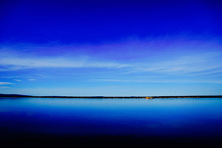 landscape photo of clear body of water under blue sky during daytime thumbnail