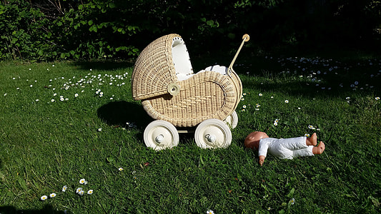 baby doll on ground near stroller thumbnail