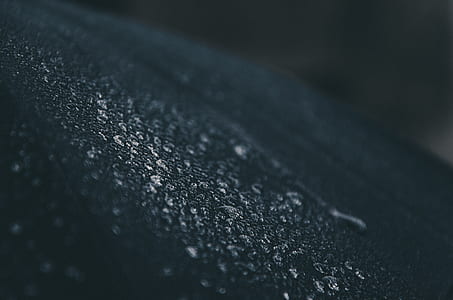 closeup photo of dew drops on black wall thumbnail
