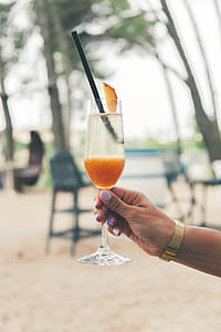 Person Holding Yellow Juice Bottle thumbnail