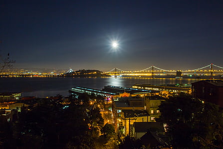 city with suspension bridges during nighttime thumbnail