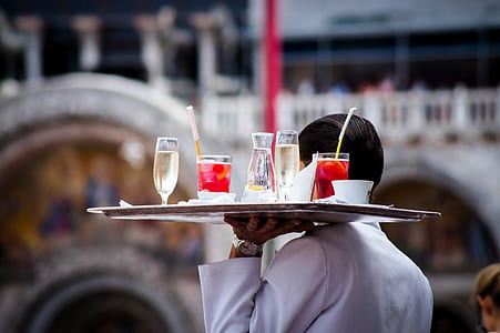 waiter holding tray with drinking glasses thumbnail