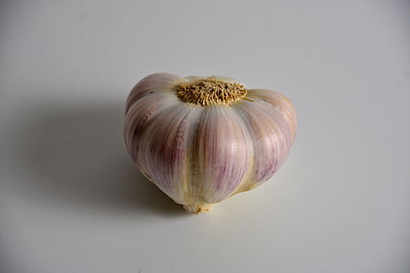 purple and white garlic on white surface thumbnail