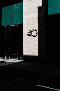 number 40 wall sign on brown concrete building thumbnail