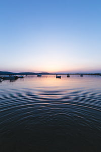 white boats on body of water during sunset thumbnail