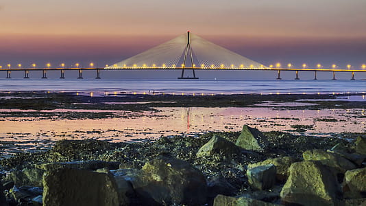 landscape photo of cable bridge above body of water thumbnail