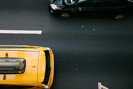 aerial view photography of yellow taxi on road thumbnail