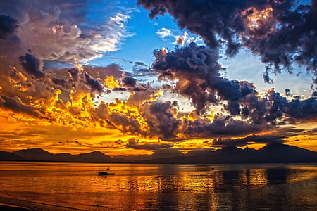 body of water under blue cloudy sky thumbnail