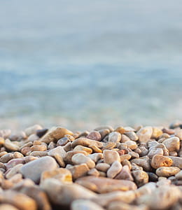 pebbles stones near body of water thumbnail