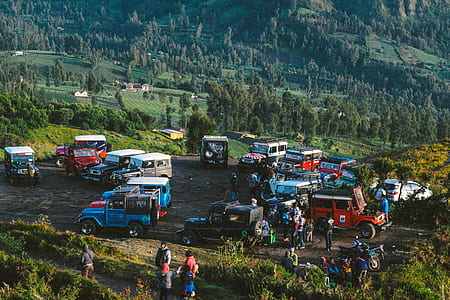 aerial photo of people with Jeep vehicles gather on mountain top thumbnail