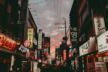 photo of concrete buildings under cloudy sky thumbnail