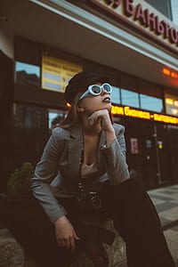 woman in gray blazer wearing sunglasses looking up thumbnail
