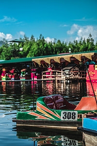green and brown floating cart with blue skies during day time thumbnail