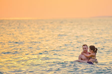 Man and Woman Swimming in a Beach thumbnail