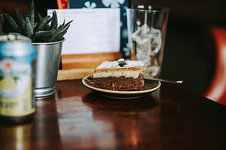 white icing-covered cake slice on saucer thumbnail