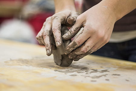 person molding clay thumbnail