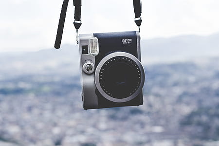 selective focus photography of black Instax insta camera thumbnail