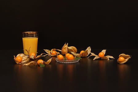 physalis fruit on brown wooden board near drinking glass thumbnail