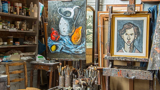 two pitcher and man paintings hanged near welsh cabinet thumbnail