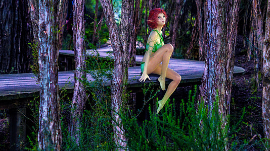 woman sitting on purple tree during daytime thumbnail