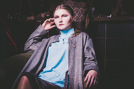 woman siting on armchair while holding her right ear with her right hand thumbnail