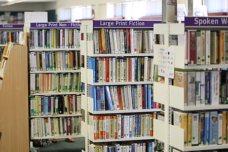 assorted-title book lot on white shelf thumbnail