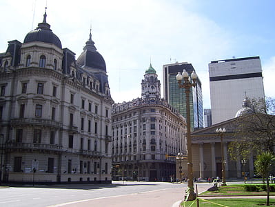 assorted-color concrete buildings near green trees thumbnail