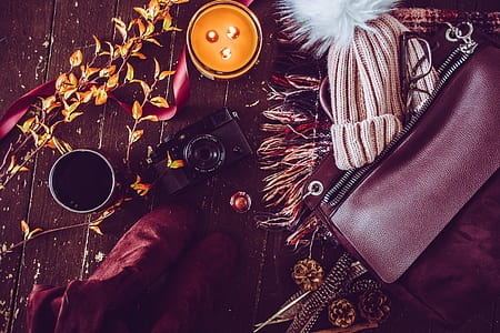 flat lane photography of votive candle; bobble hat; leather thumbnail