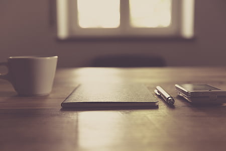 white ceramic cup on top of table thumbnail