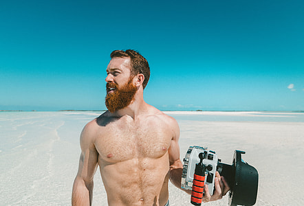 man standing on gray sand thumbnail