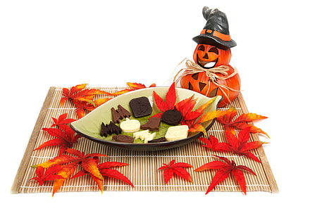 Jack-o'-lantern beside chocolate on coaster thumbnail