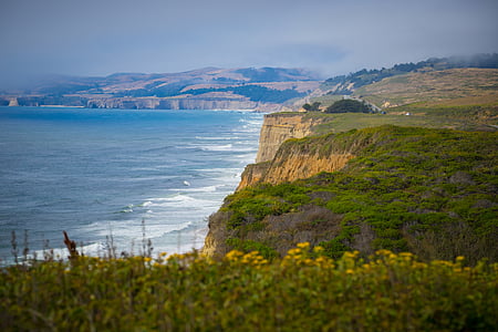 green cliff near water thumbnail