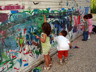 four children painting wall during daytime thumbnail