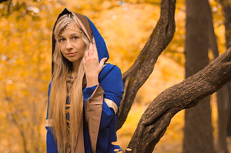 shallow focus photography of woman wearing blue robe thumbnail