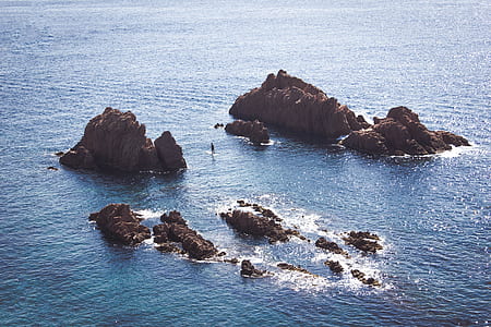 rock formation on body of water thumbnail