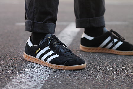 person wearing black adidas Superstar low-top sneakers thumbnail