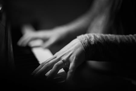 grayscle photo of person playing piano thumbnail