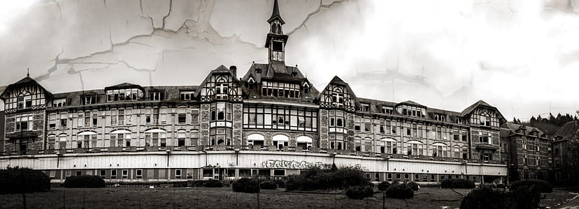 grayscale photography of building near road with trees thumbnail