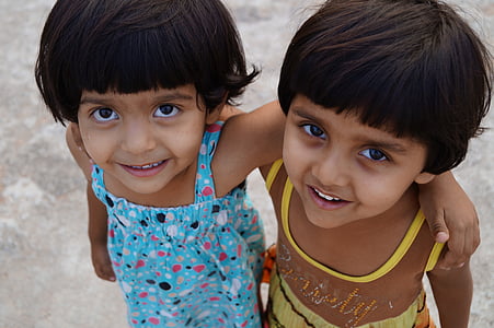 twins wearing blue and yellow dresses thumbnail