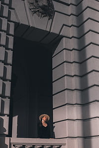 woman in black dress looking through a terrace thumbnail