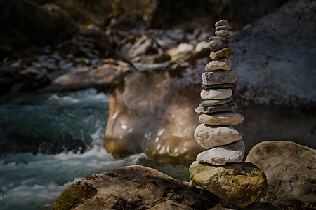 beige stacked stones near body of water at daytime thumbnail