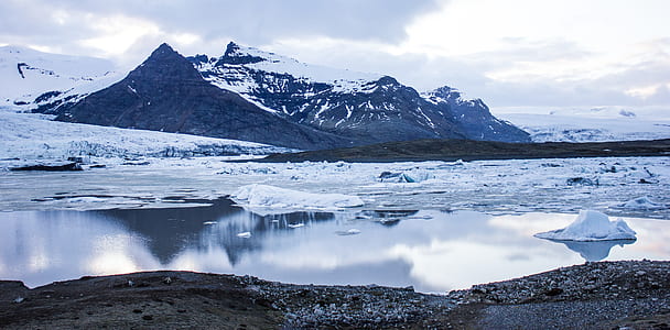 snow capped mountain near body of water thumbnail