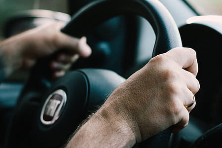 selective focus photography of person driving FIAT car thumbnail