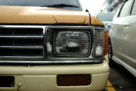 beige vehicle parked beside white vehicle thumbnail