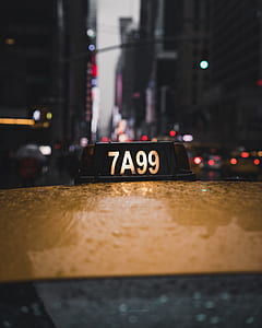 selective-focus photography of 7A99 taxi signage thumbnail